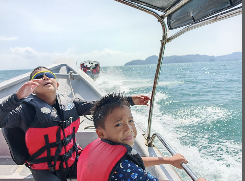 Guest photo: two children in life jackets on the boat at sea, Langkawi